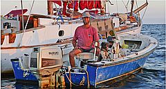 Joe with his boats and dog
